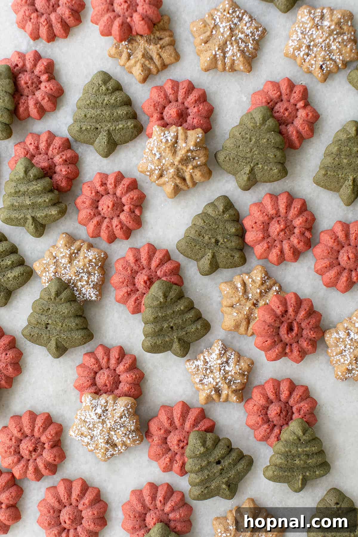 Melt-in-Your-Mouth Spritz Cookies 2 Colorful spritz cookies shaped as trees, snowflakes, and flowers decorated for Christmas.