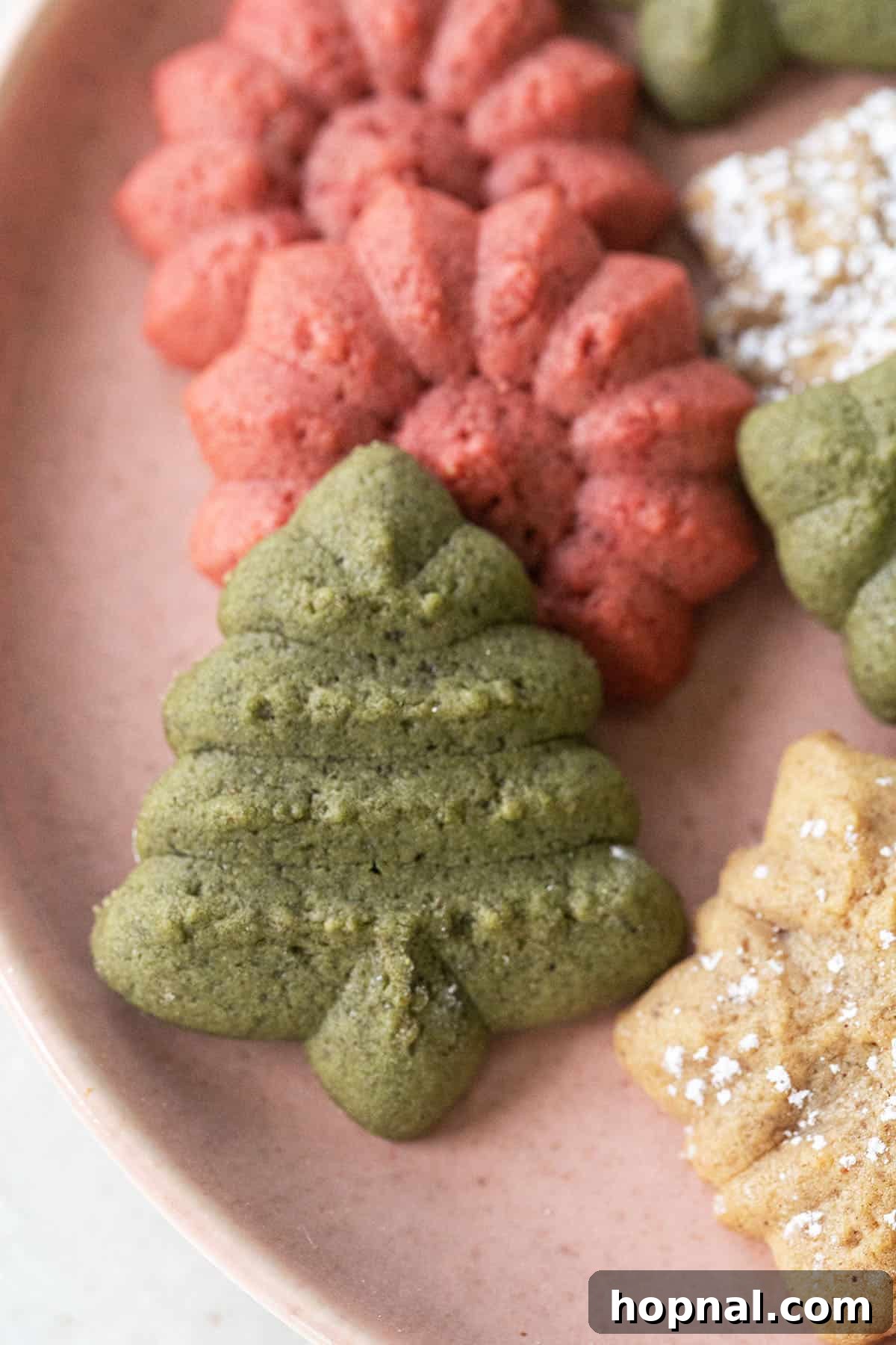Melt-in-Your-Mouth Spritz Cookies 11 Christmas spritz cookie recipe displayed as an assortment of festive cookies.