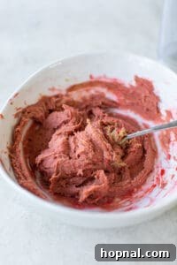 Melt-in-Your-Mouth Spritz Cookies 17 red cookie dough in a bowl