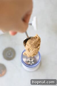 Melt-in-Your-Mouth Spritz Cookies 18 adding dough into a cookie press