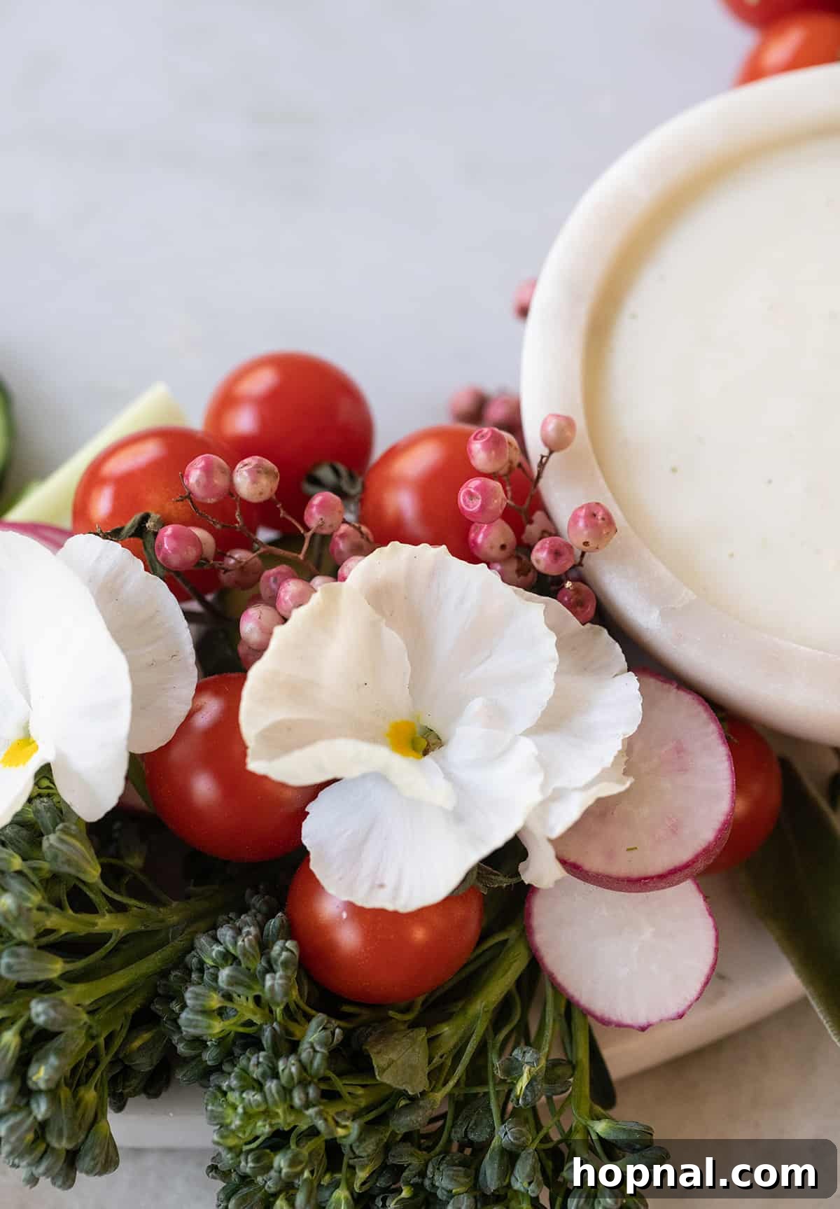 Edible flowers delicately placed on a fresh vegetable platter.