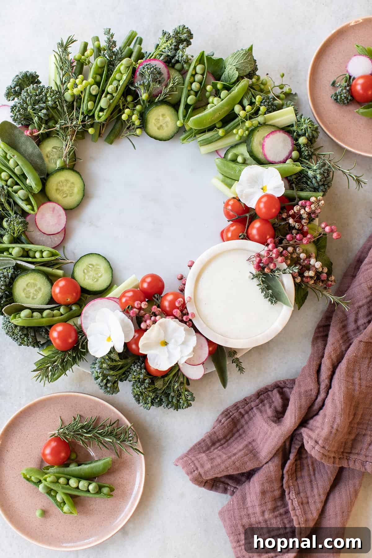 A festive holiday wreath vegetable platter filled with fresh, vibrant vegetables and herbs.