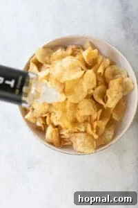 pouring truffle oil over potato chips