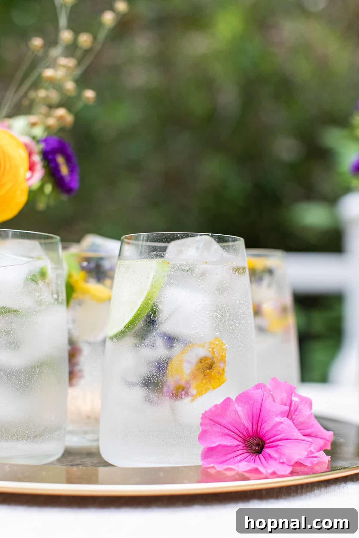 Elegant Vodka Soda with floral ice cubes and lime garnish