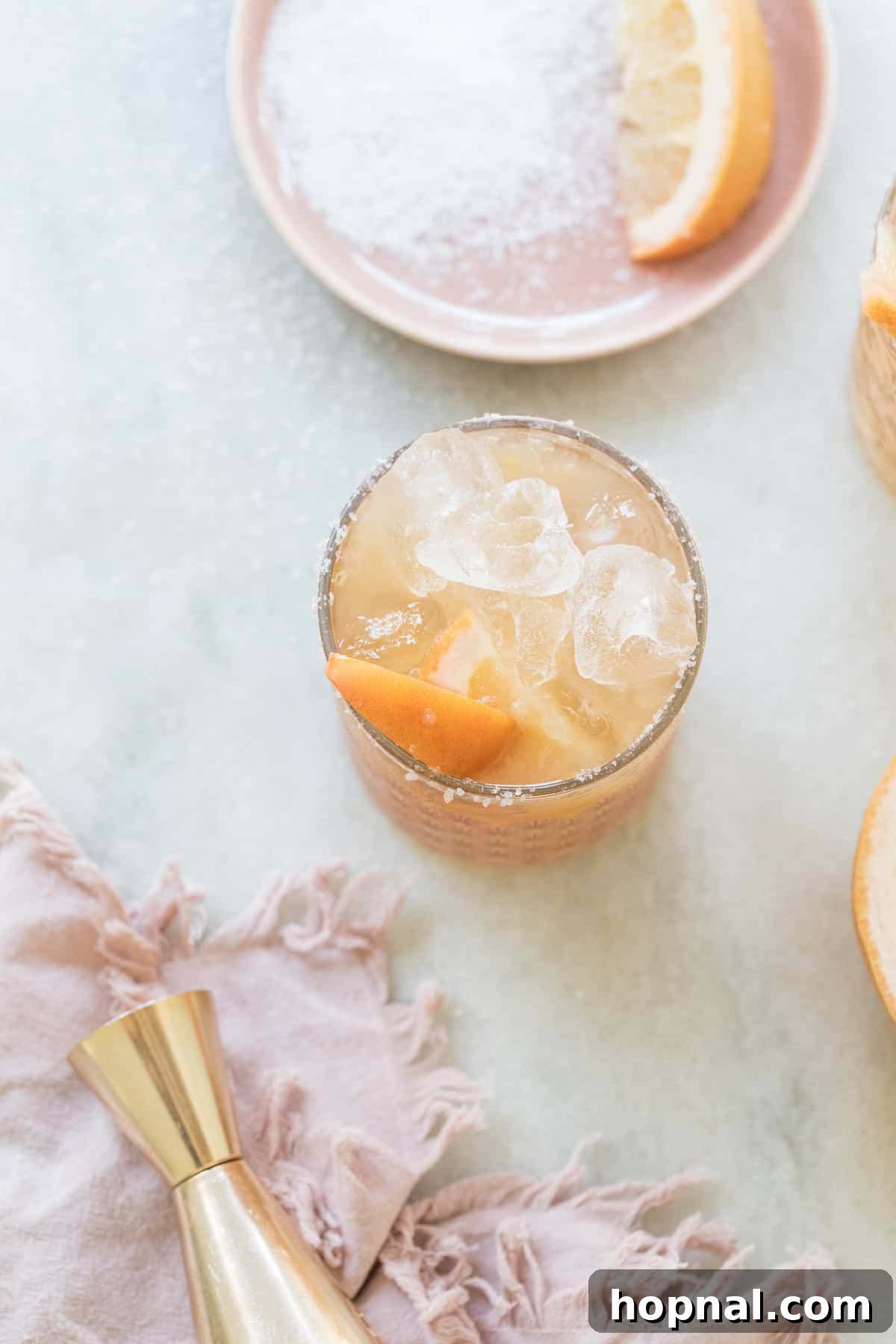 Peachy Salty Dog cocktail with grapefruit and peach slices