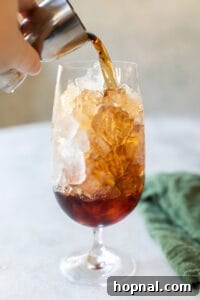 pouring Jagermeister into a glass filled with ice
