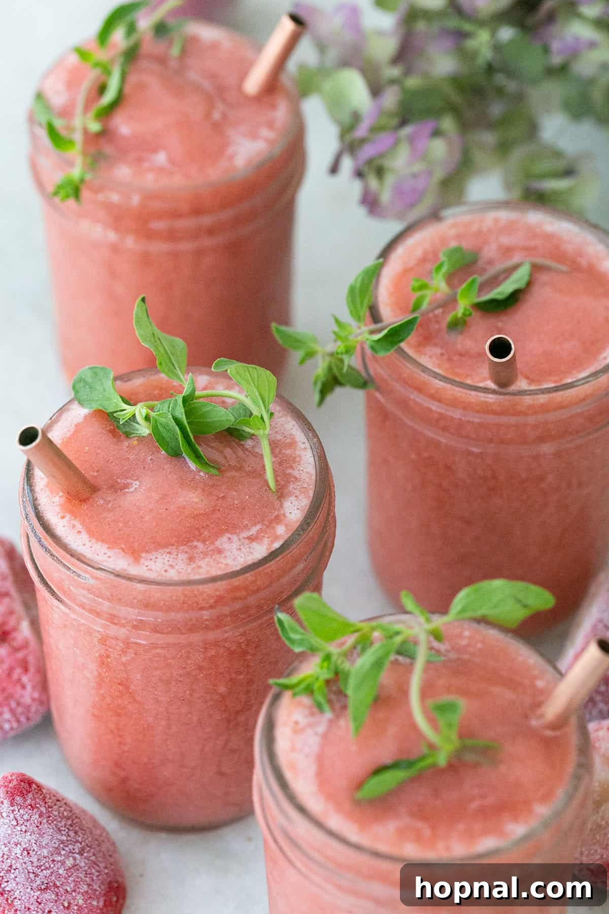 Blush & Sip 12 Strawberry froze with fresh herbs and copper straw.