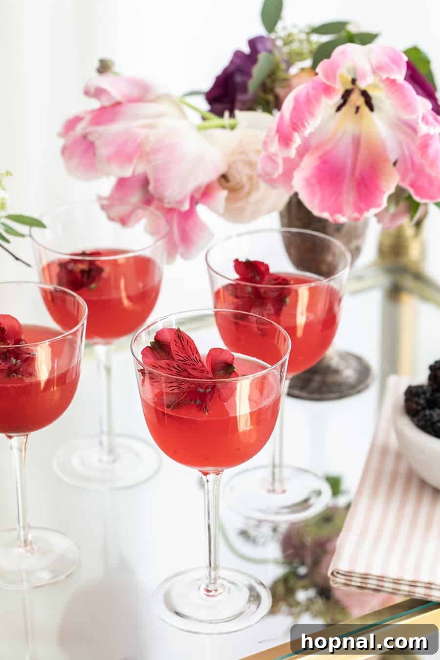 Blush & Sip 25 Pink cocktails on a tray with flowers.