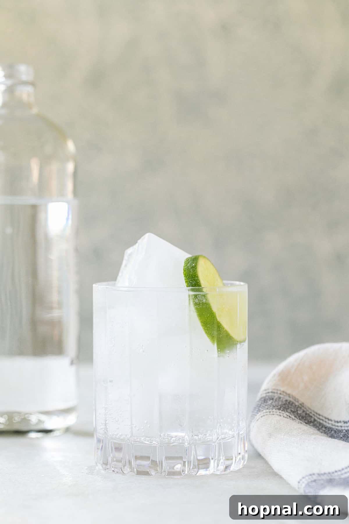Sparkling water in a glass with lime.
