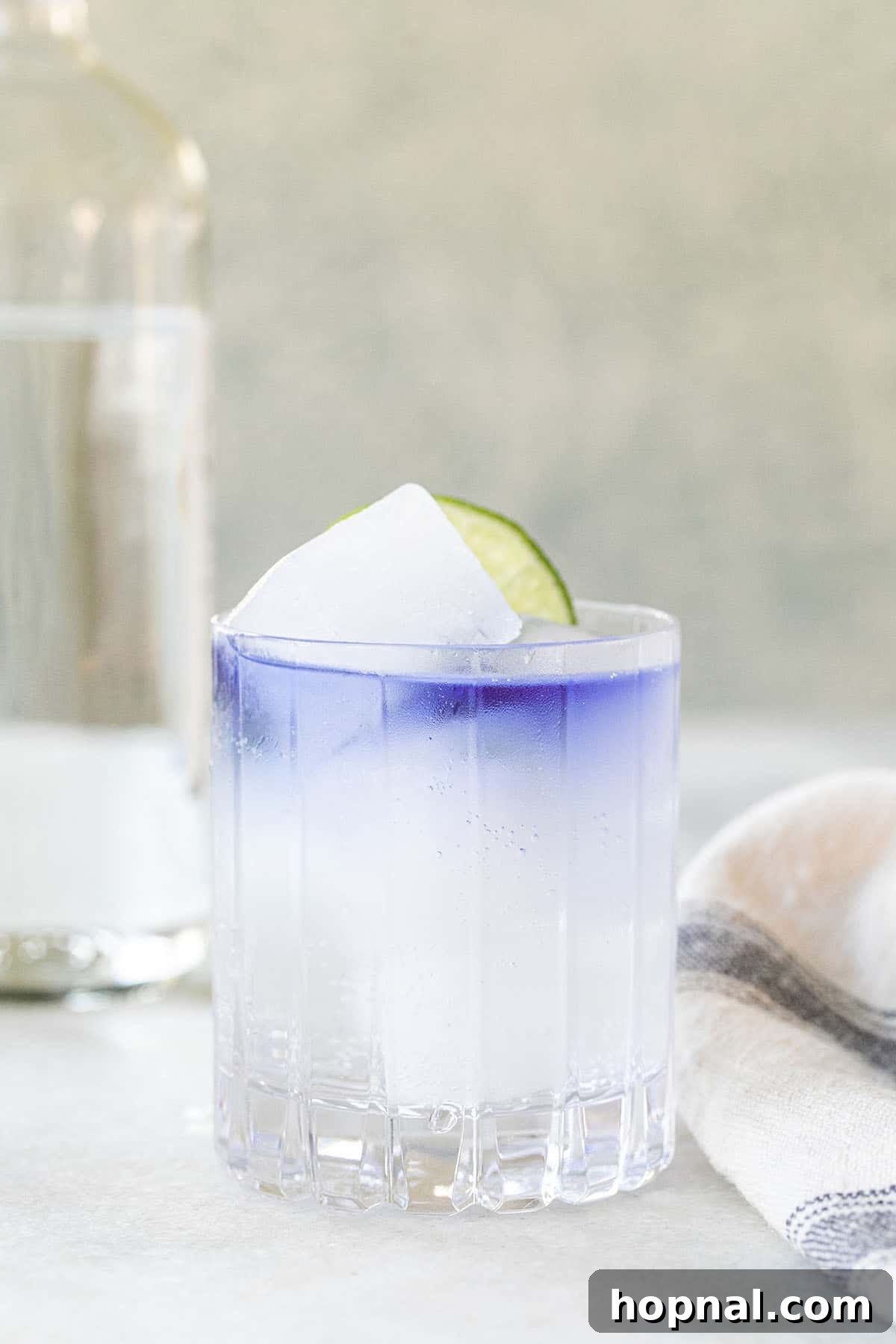 Soda water with purple gin over the top.