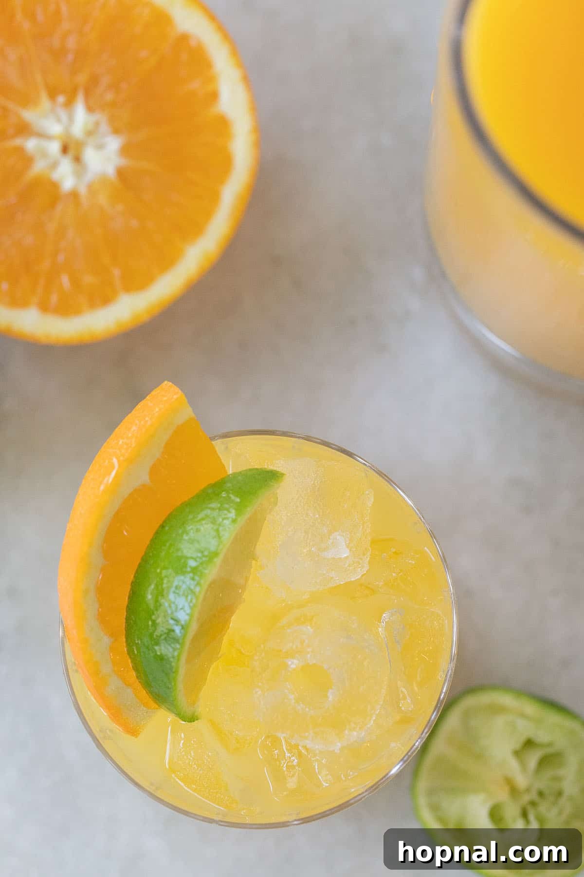 A perfectly balanced Tequila and Orange Juice cocktail, garnished with a fresh lime and orange wedge, emphasizing its appeal.