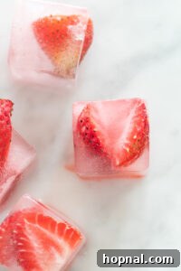 Frozen strawberry ice cubes in a tray.