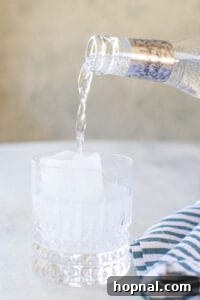 pouring tonic water over ice