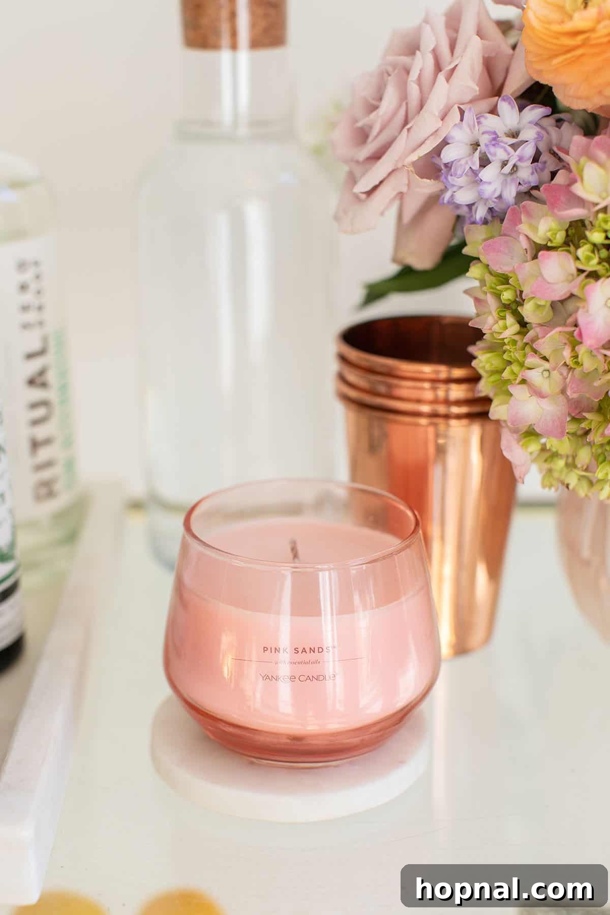 The Art of Spring Bar Styling 5 Rose scented Yankee Candle on a spring-themed bar cart