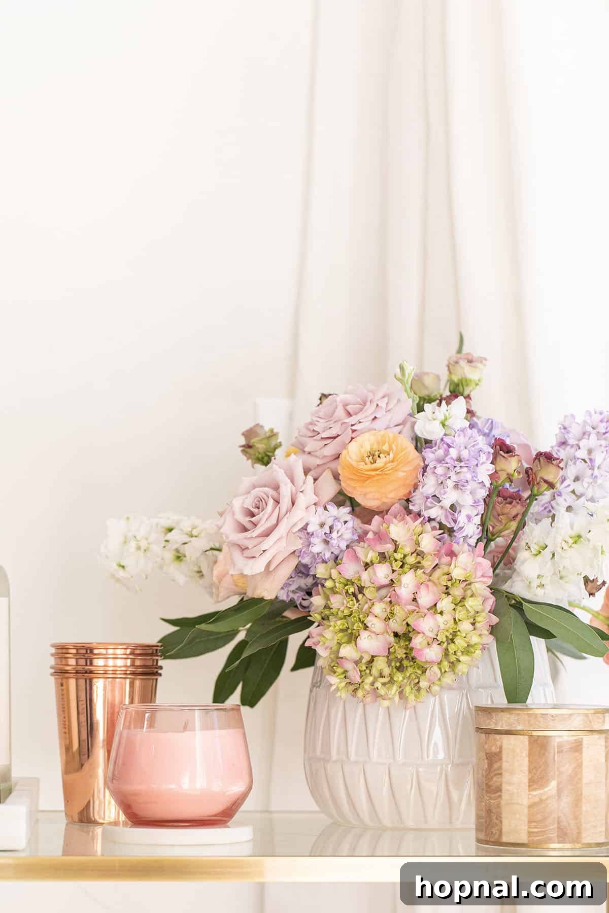 The Art of Spring Bar Styling 6 Flowers and Yankee Candle Studio Collection candles arranged on a bar cart