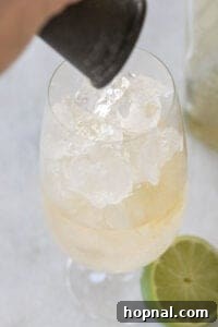 Whiskey Ginger Sparkle 8 pouring whiskey in a glass filled with ginger ale