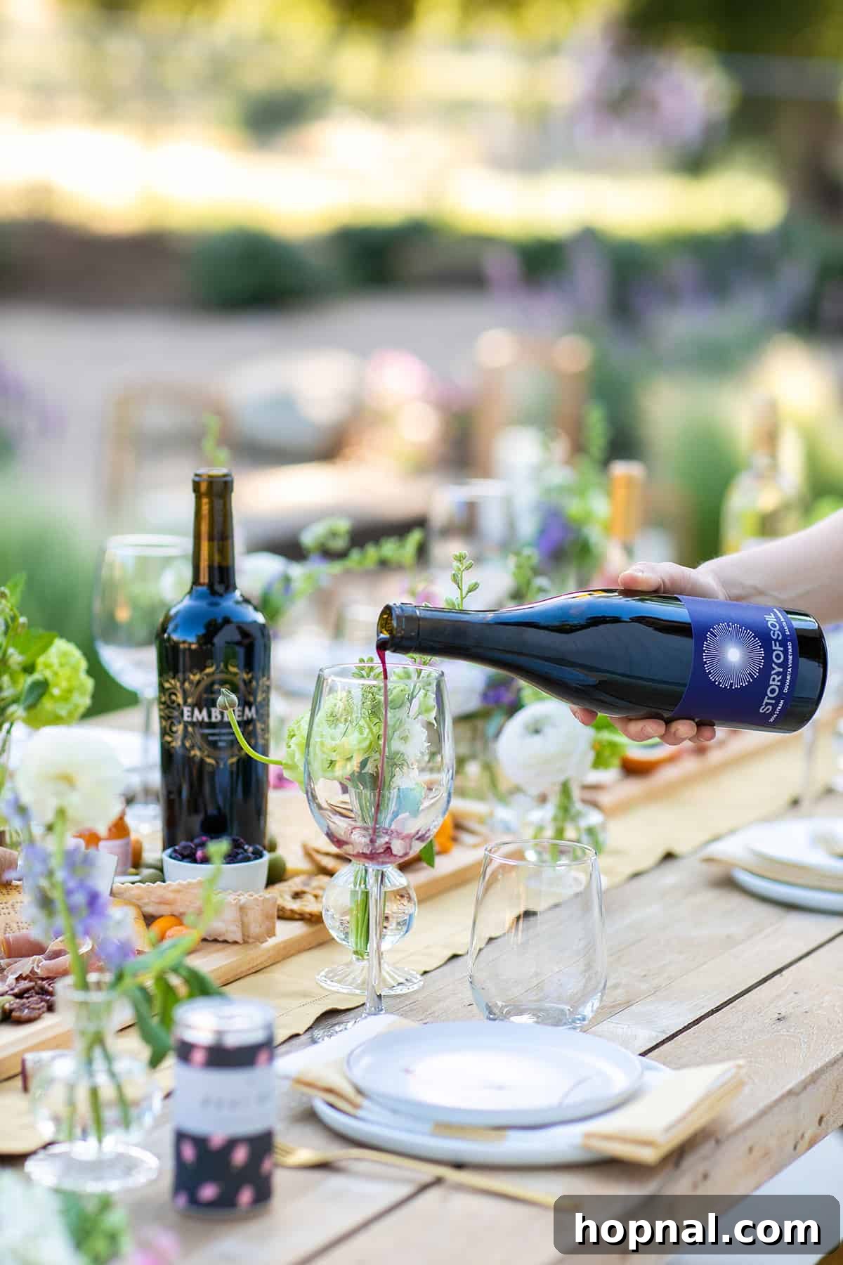 pouring red wine into a wine glass 
