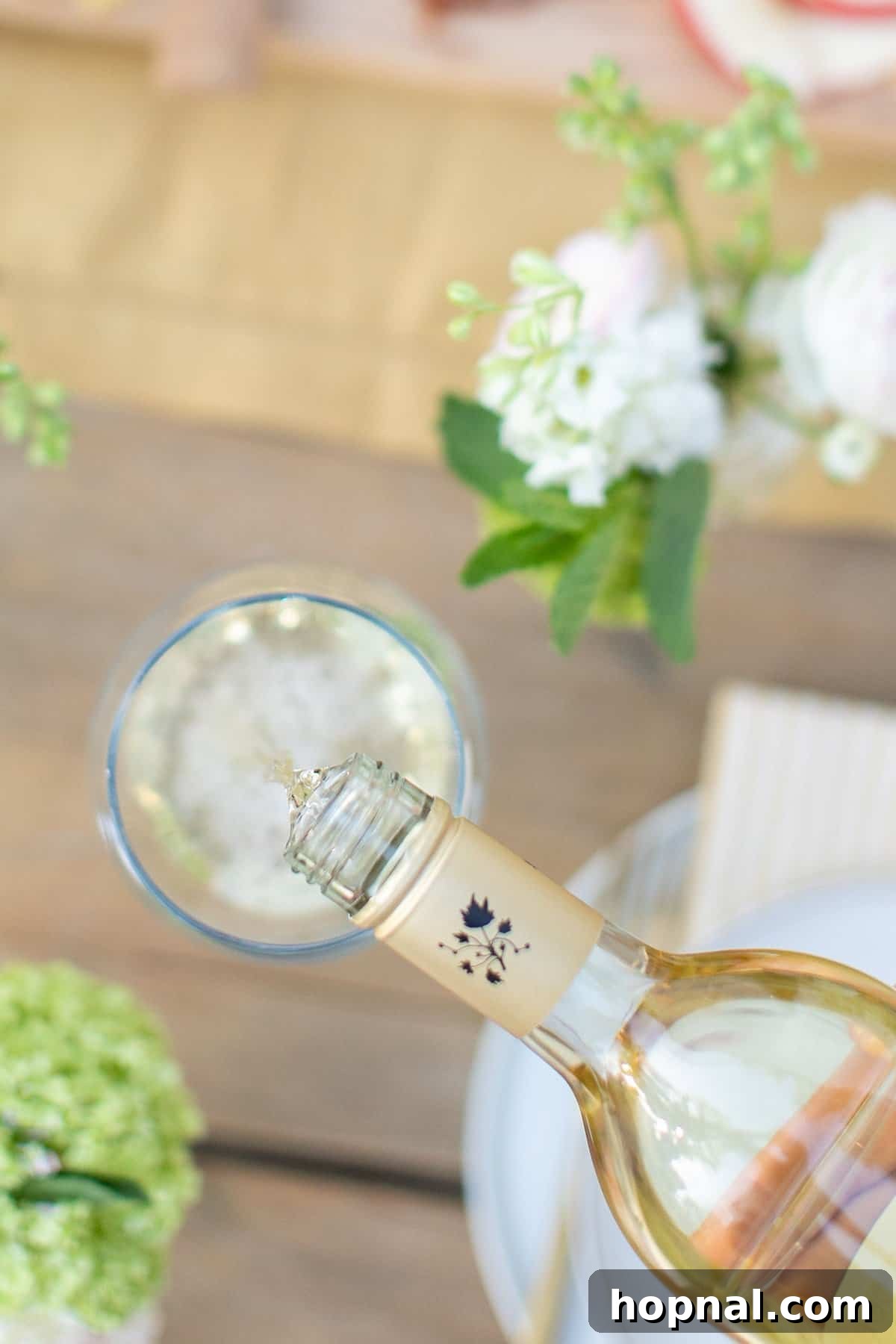 pouring white wine into a glass