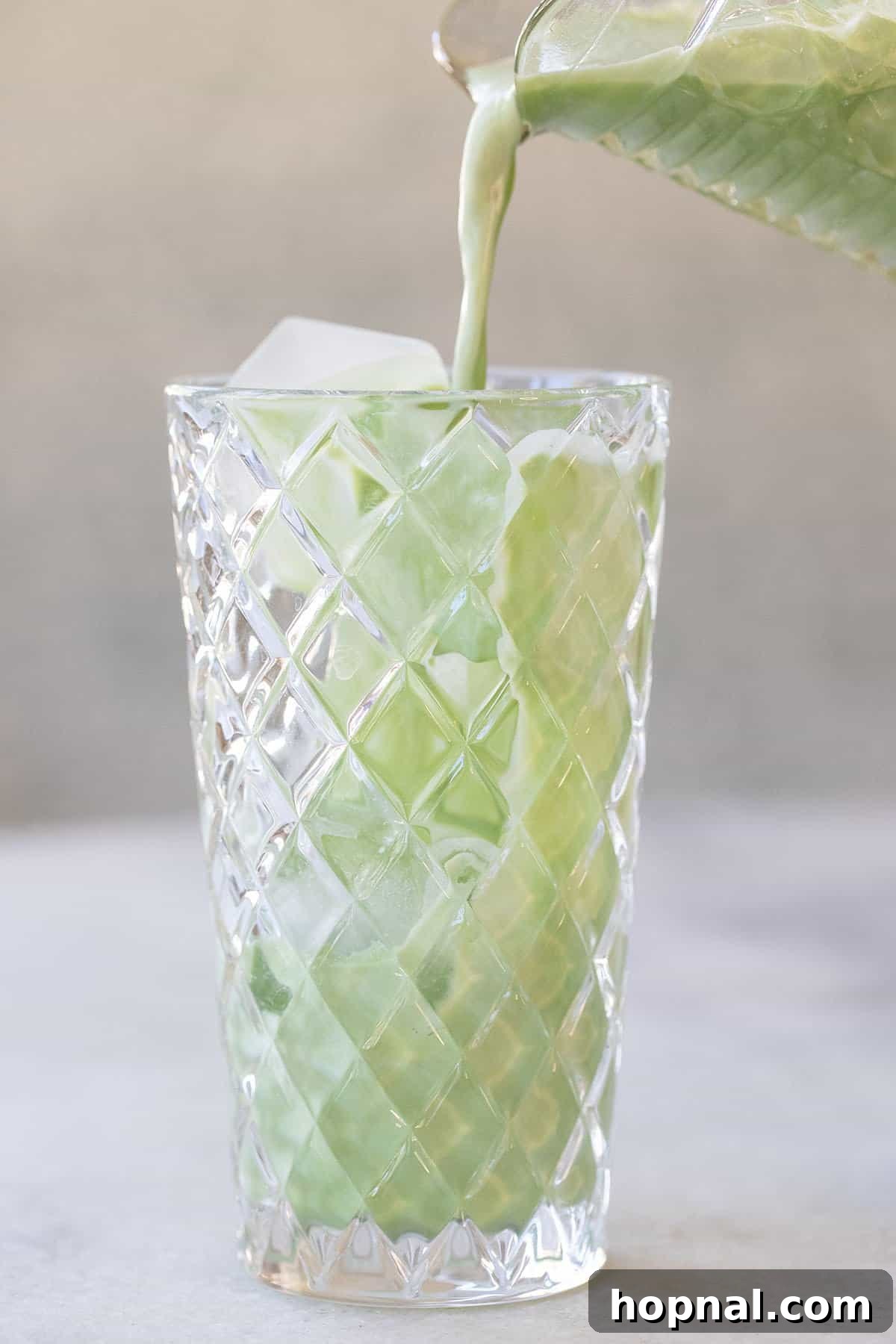 An easy iced matcha latte recipe in a glass, ready to be enjoyed.