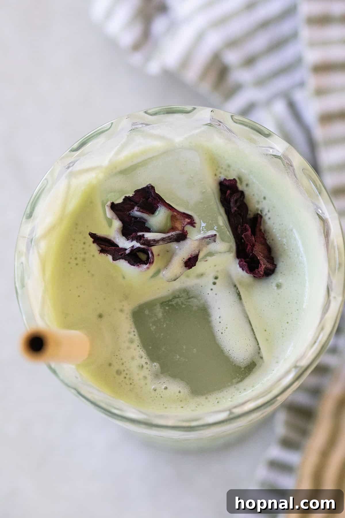 A refreshing iced matcha latte in a glass, ready for a delicious sip.