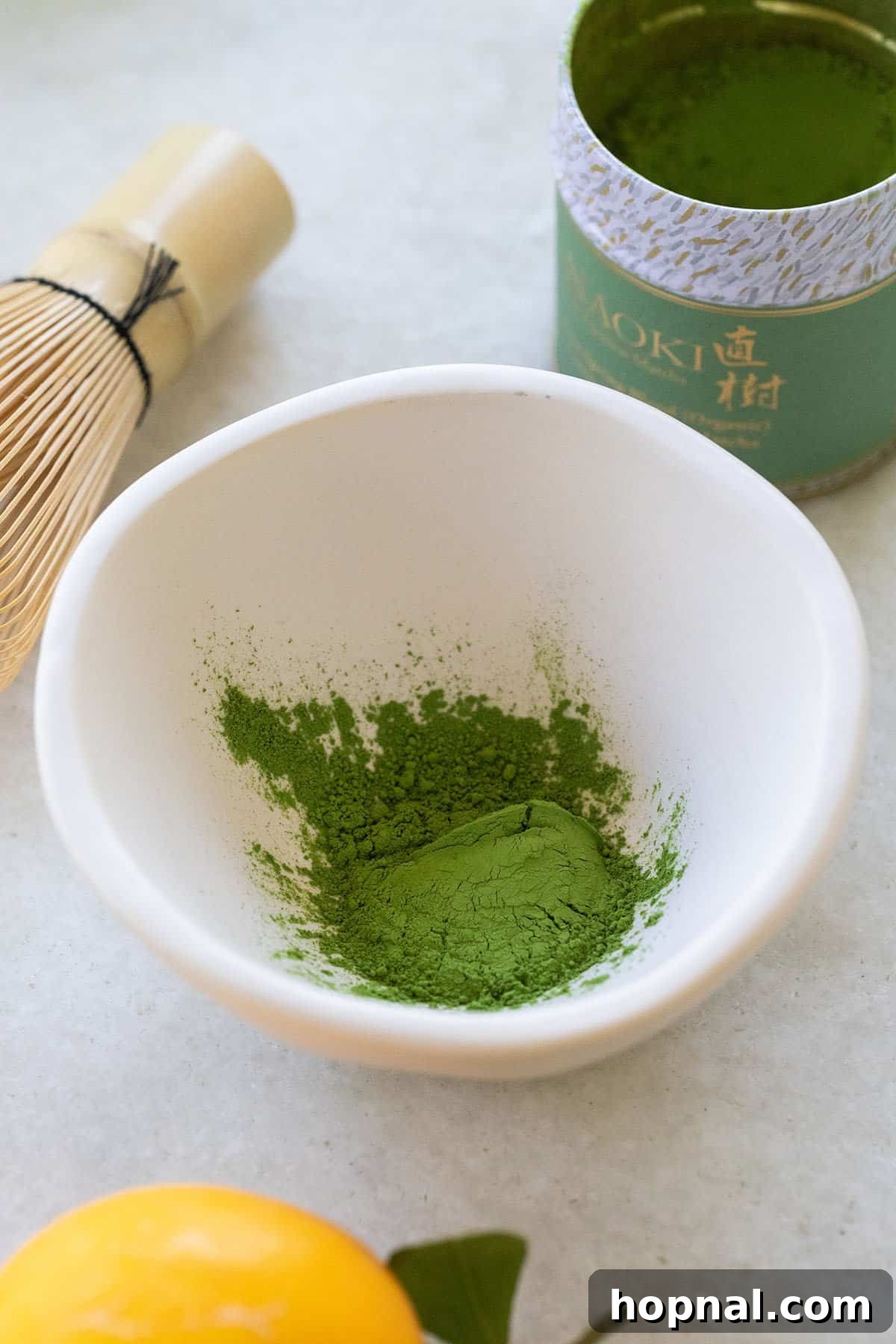 Matcha Spritz: Your Cool Green Escape 6 Matcha powder in a traditional bowl with a bamboo whisk, ready for preparation.