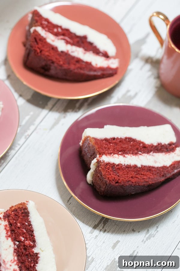 Effortless Red Velvet Cake Recipe 3 Side shot of individual slices of easy red velvet cake with thick cream cheese frosting