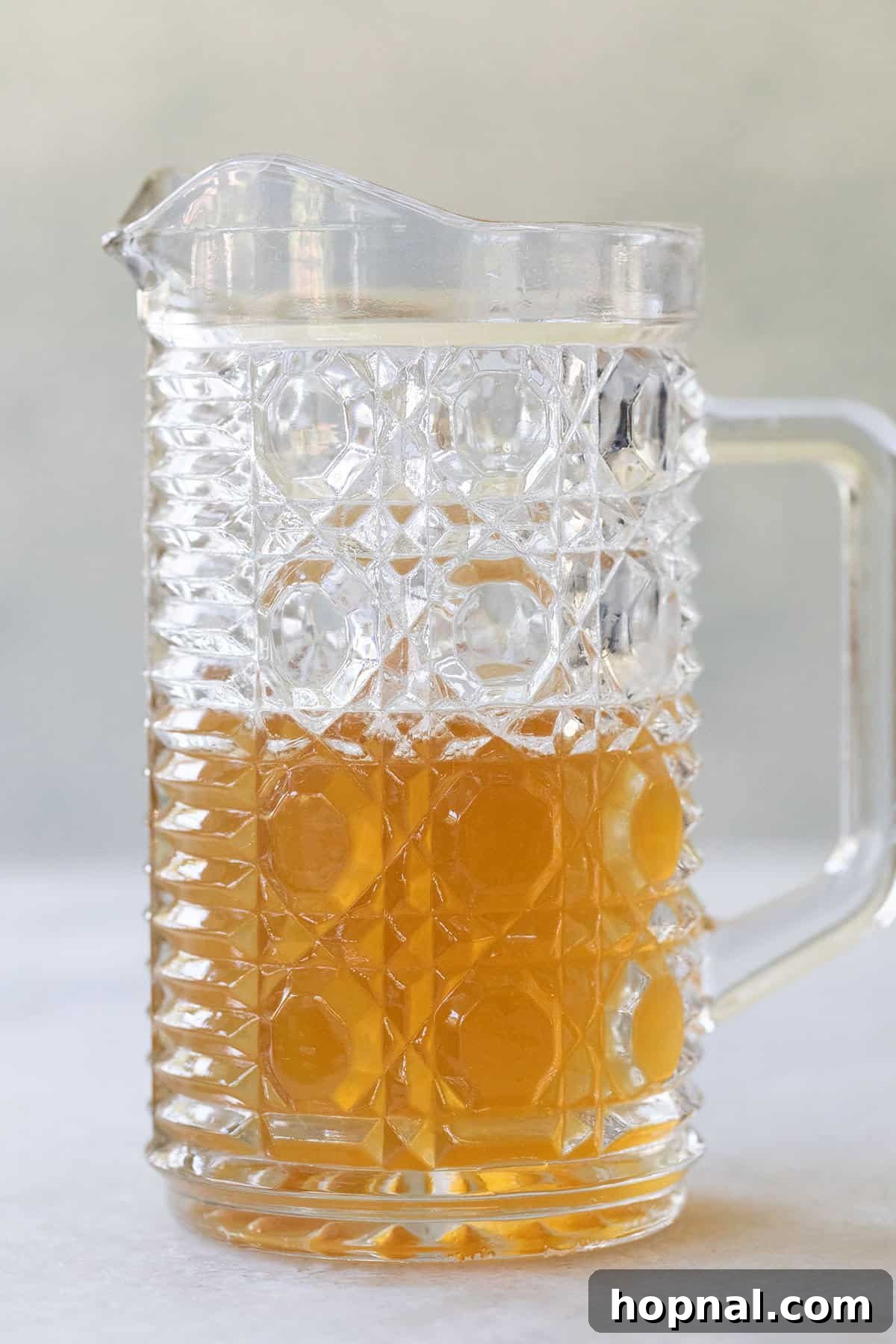 Honey simple syrup made with honey and water in a pretty glass jar.