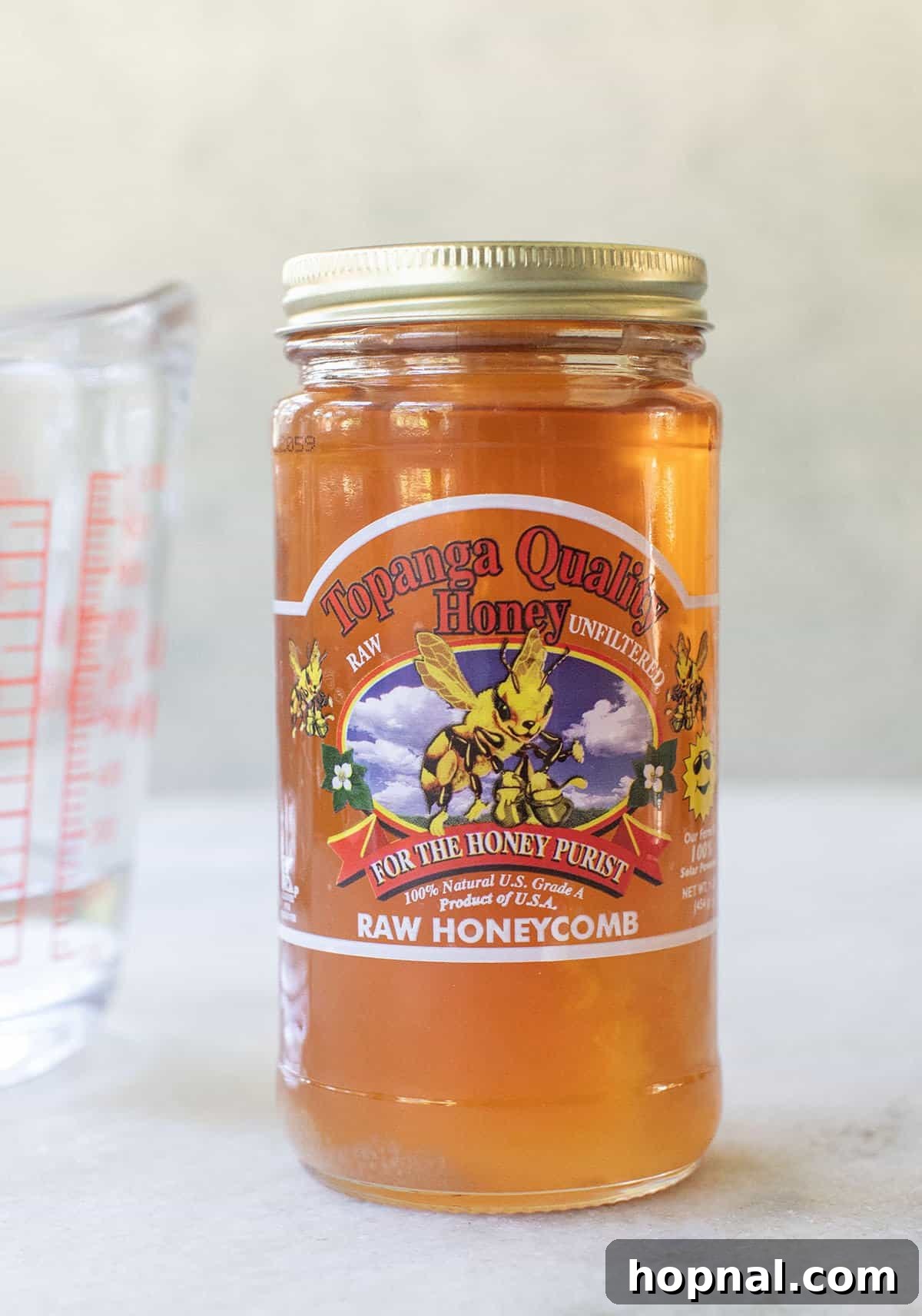 A jar of local raw honey is used to make it into liquid honey.