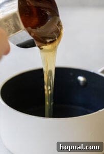 pouring honey into a saucepan
