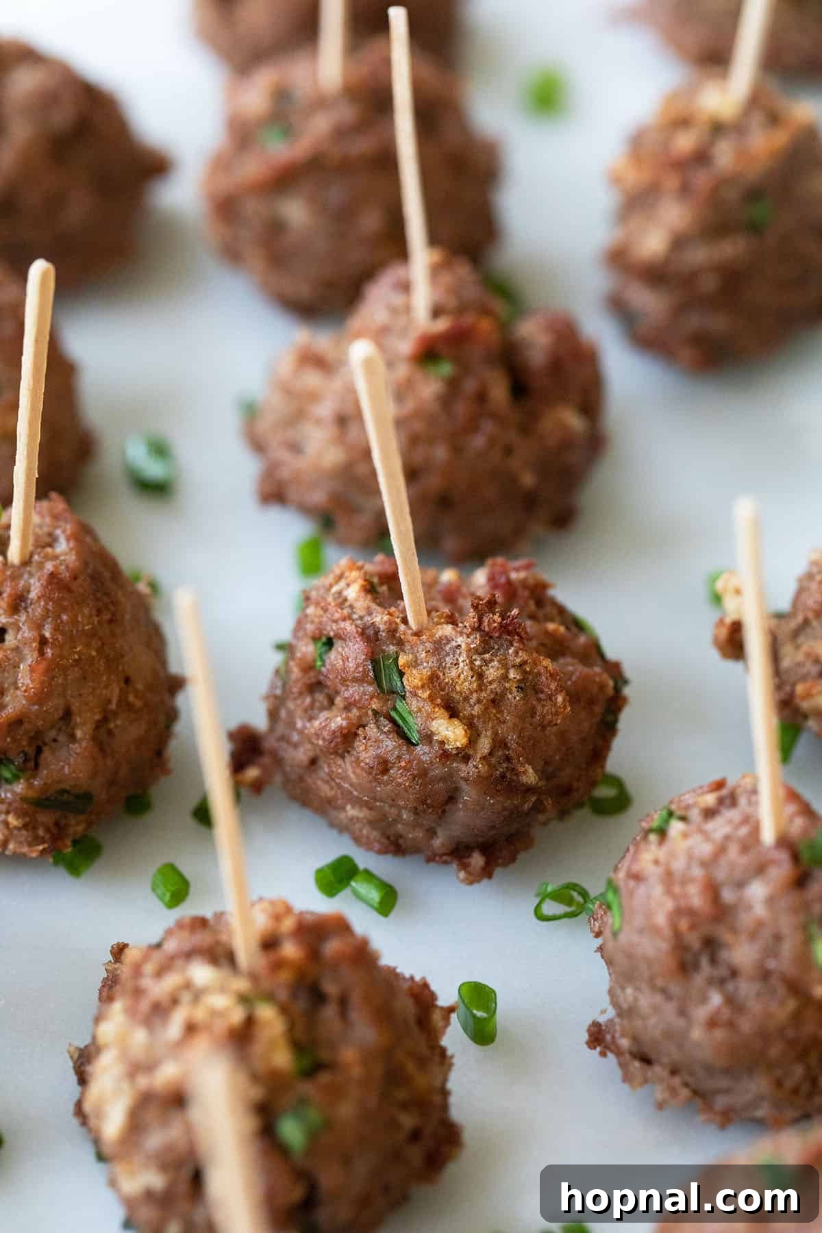 Simple Meatball Bites 2 Delicious meatball appetizers arranged on a platter for a party.