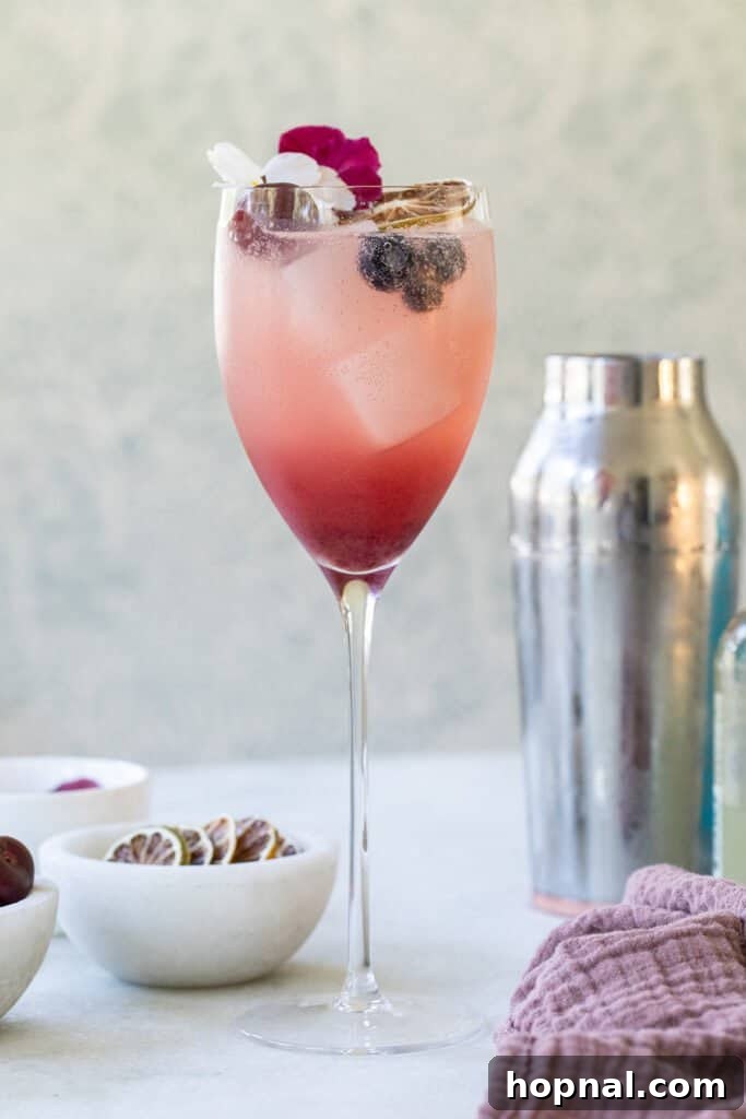 Light and refreshing gin spritz recipe with fresh fruit garnish