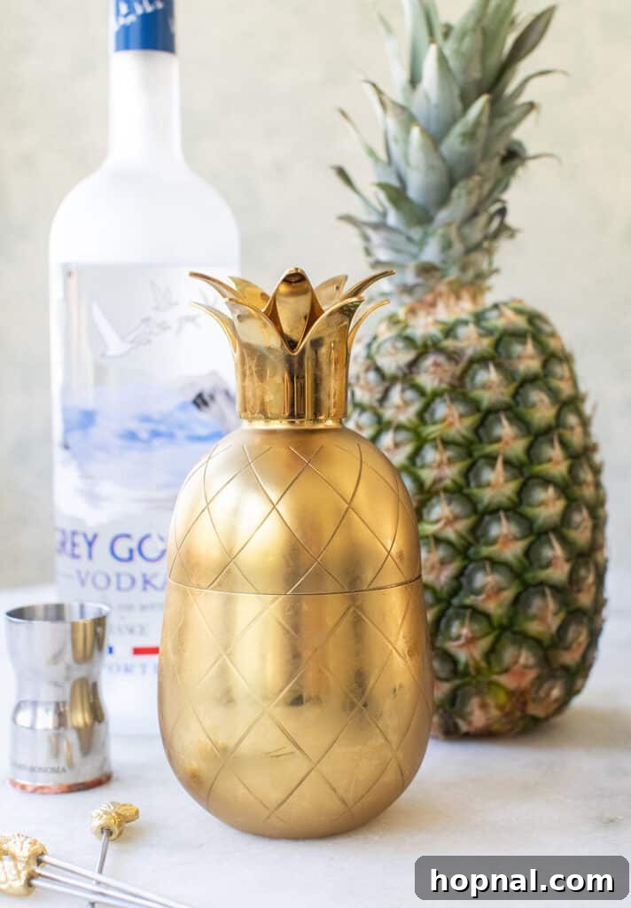 Tropical Pineapple Vodka Elixir 5 A stylish pineapple-shaped cocktail shaker, ready for mixing ingredients.