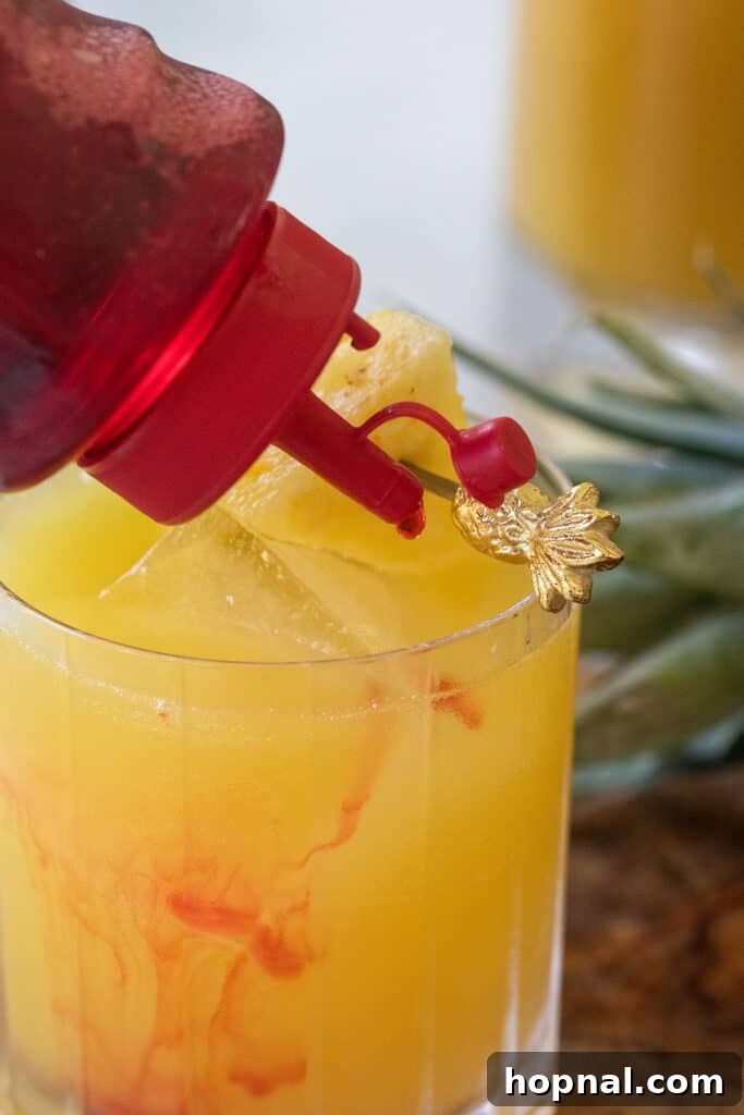 Tropical Pineapple Vodka Elixir 7 A beautiful Pineapple Vodka Cocktail with a drizzle of grenadine creating an ombré effect at the bottom.