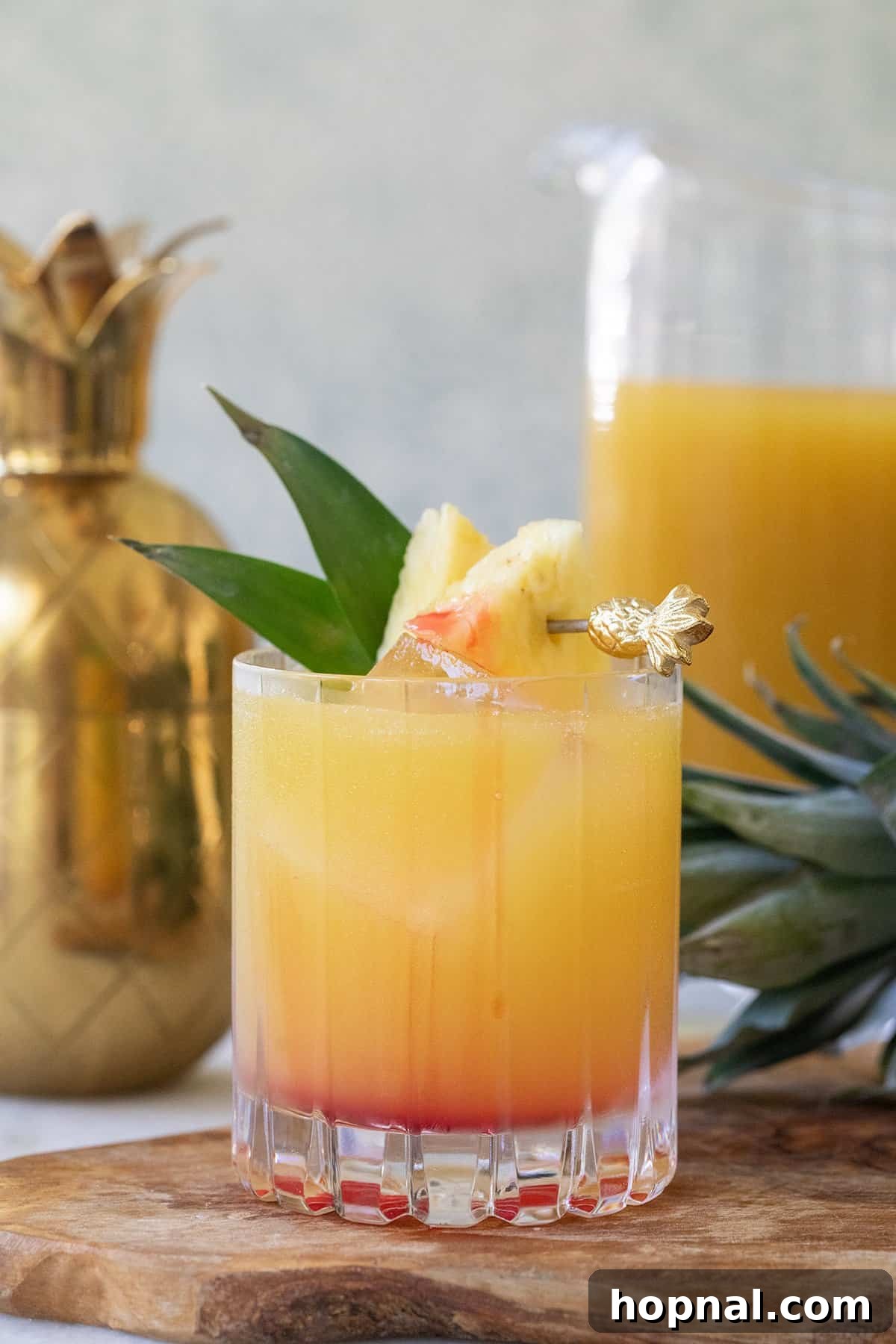 Tropical Pineapple Vodka Elixir 8 A stunning view of a Pineapple Vodka Cocktail with a layer of red grenadine settling at the bottom, creating a beautiful gradient effect.