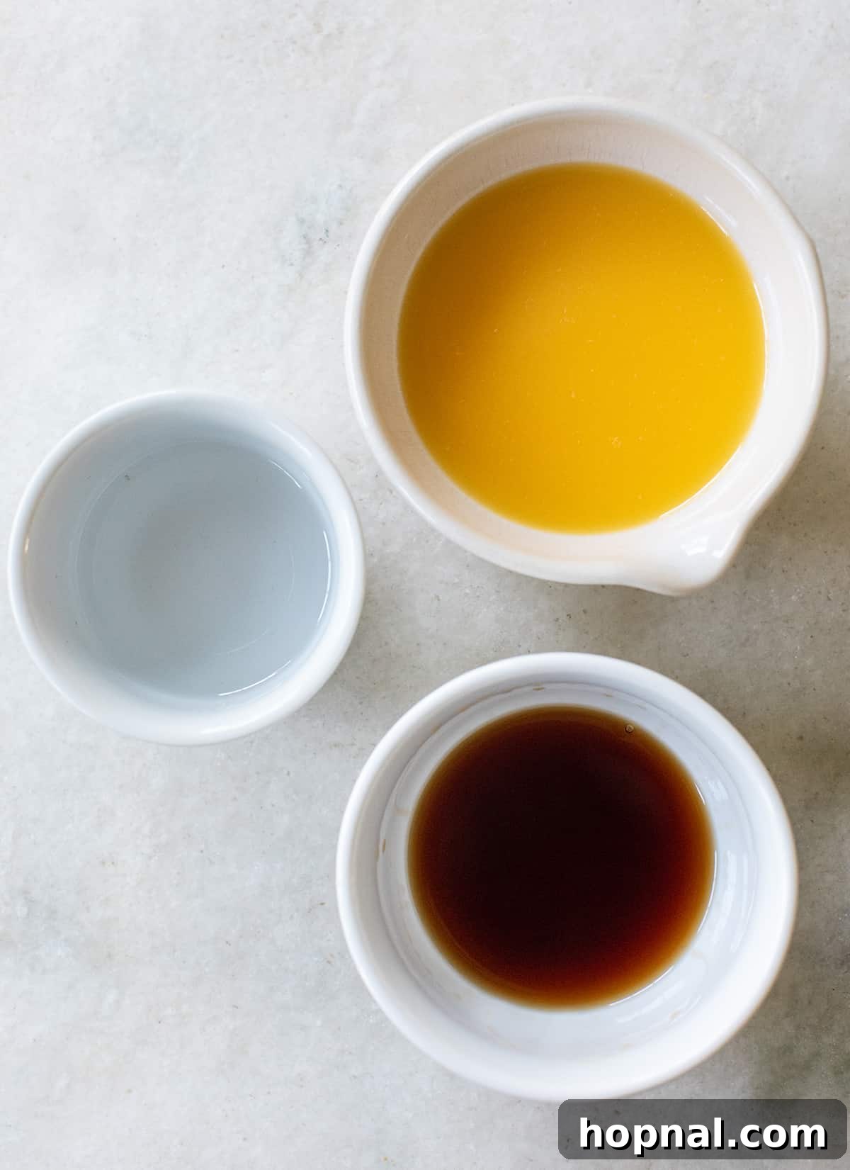 Bowls of rum, orange juice, and vodka, ready for cocktail mixing.
