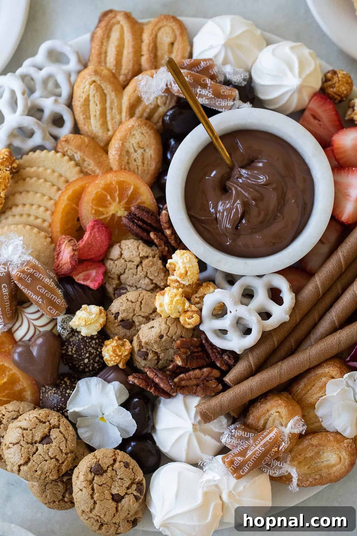 Sweet Grazing Board 3 A vibrant dessert board showcasing an abundant selection of chocolates, various candies, and sweet dips arranged artfully.
