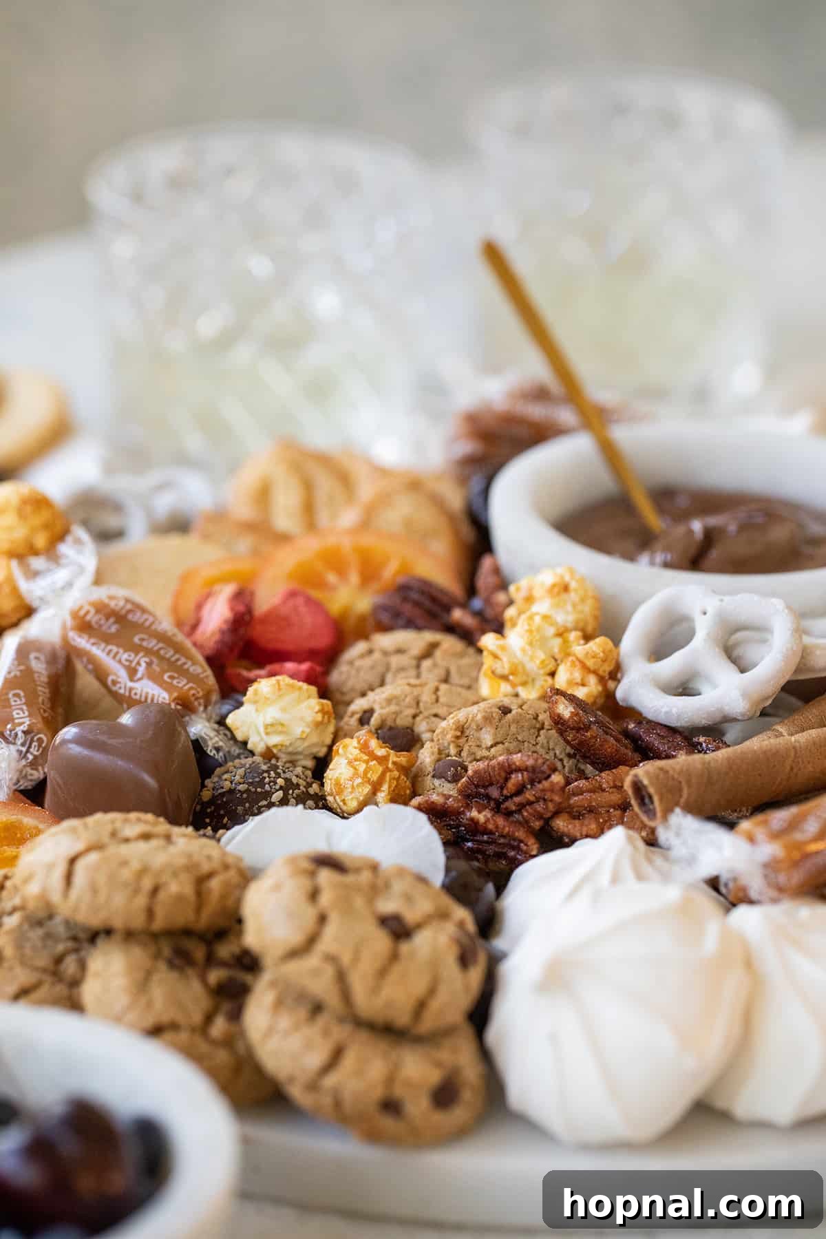 Sweet Grazing Board 9 A stunning dessert charcuterie board featuring an array of cookies, mixed nuts, and lush chocolate-covered fruit.