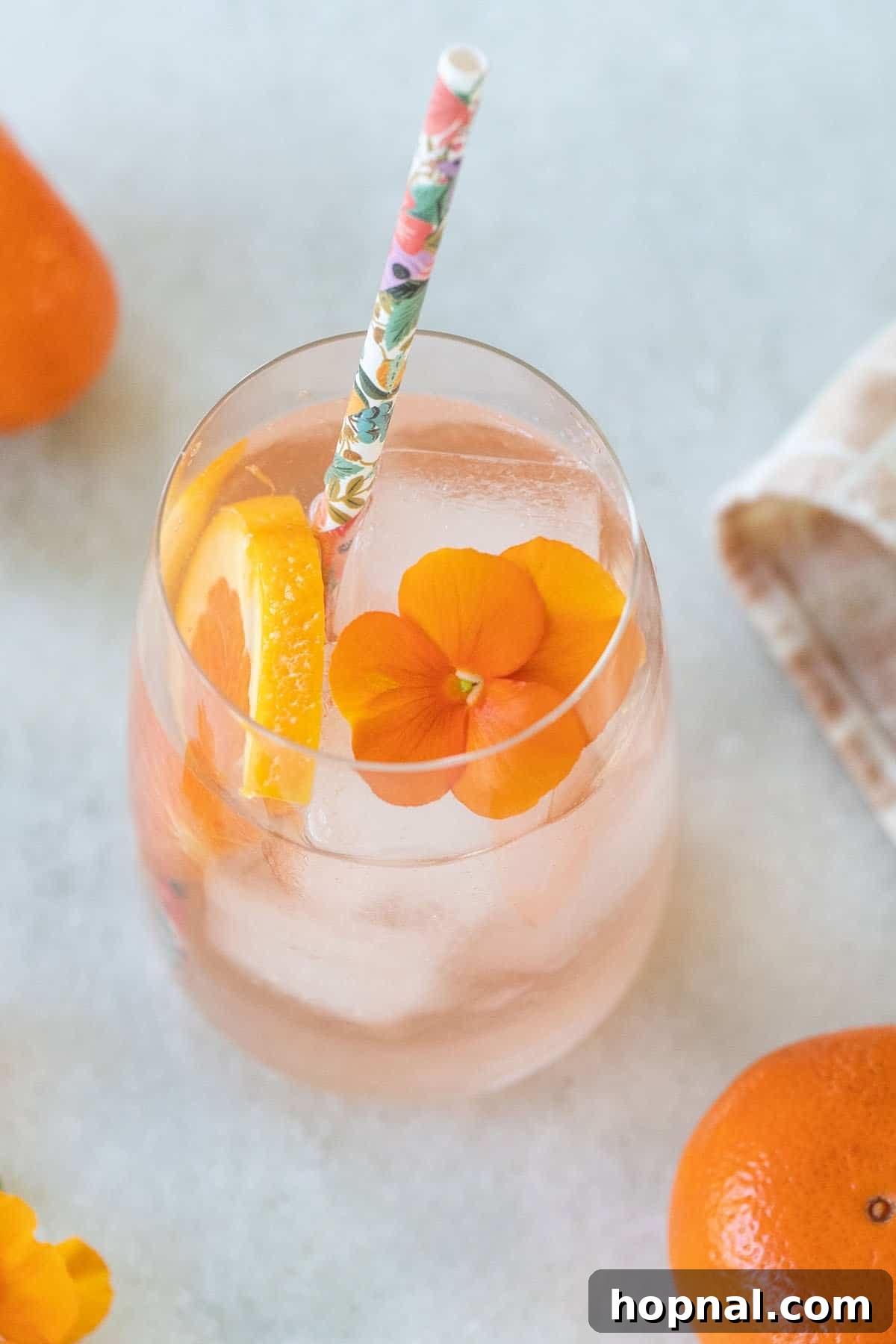 Effortless Rosé Refresher 7 A vibrant and refreshing wine cocktail in a clear glass, perfect for a summer day.
