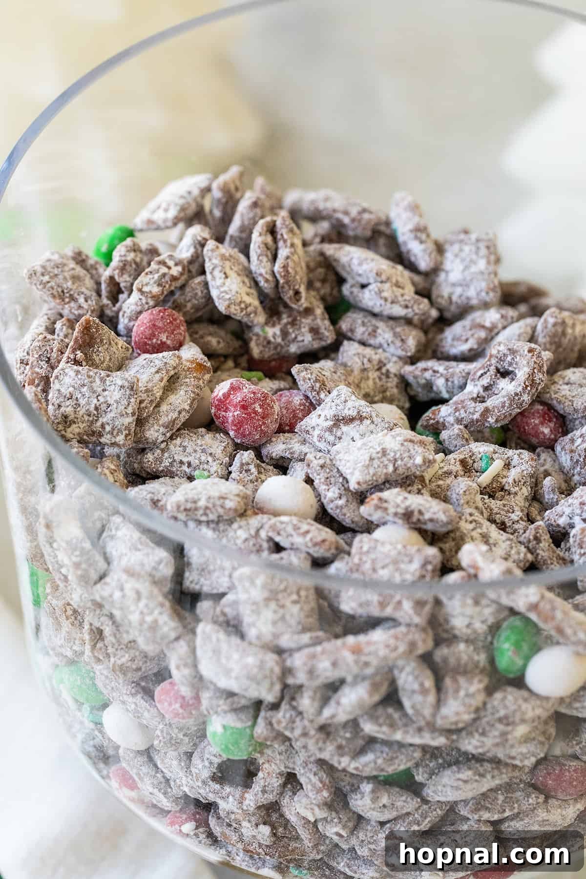Magic Reindeer Dust 9 Christmas reindeer chow beautifully presented in a large glass trifle dish, showcasing its festive layers and inviting appearance, perfect for a holiday buffet.