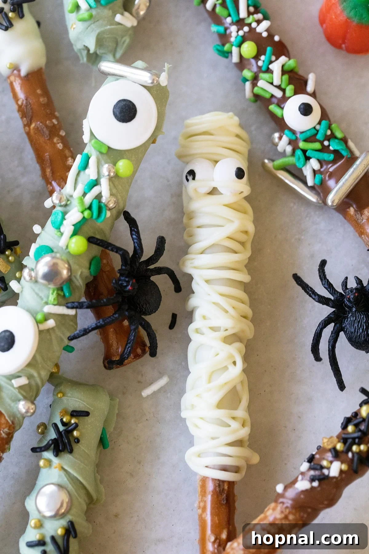 Mummy Halloween pretzel rod with sprinkle eyes and white chocolate.