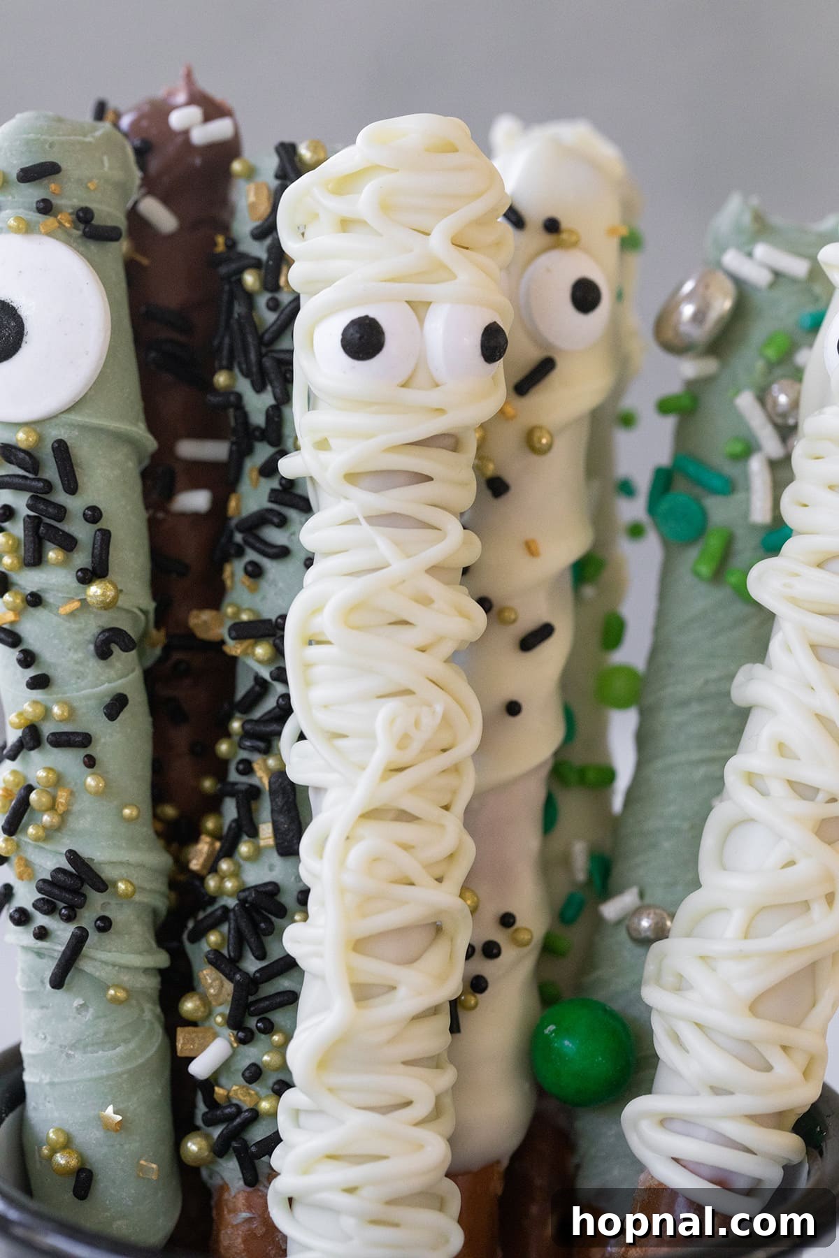 Pretzel rods dipped in chocolate and sprinkles.