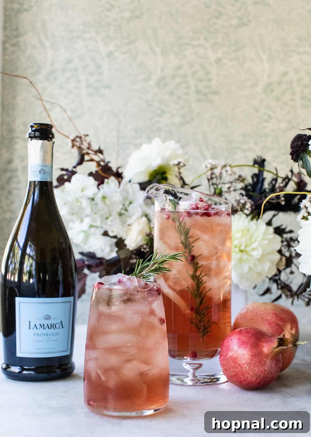 Festive Prosecco Fizz 3 Close-up of Prosecco punch recipe with red pomegranates and rosemary.