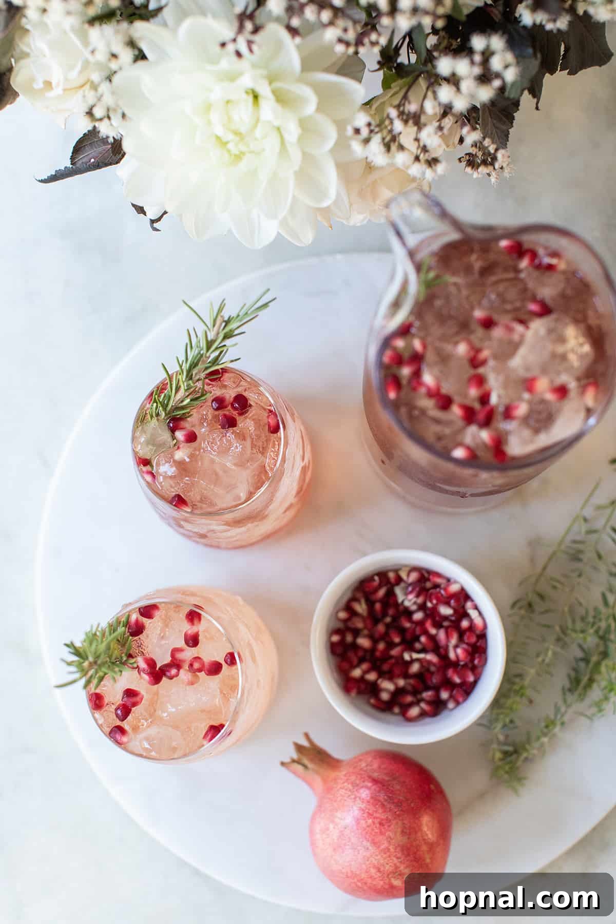Festive Prosecco Fizz 5 Glasses filled with vibrant pomegranate punch recipe, ready for the holidays.