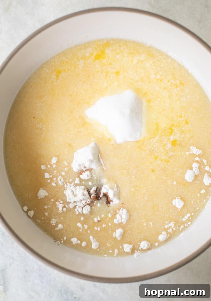 Wet and dry ingredients prepared in separate bowls, ready to be combined for the apple cake batter.