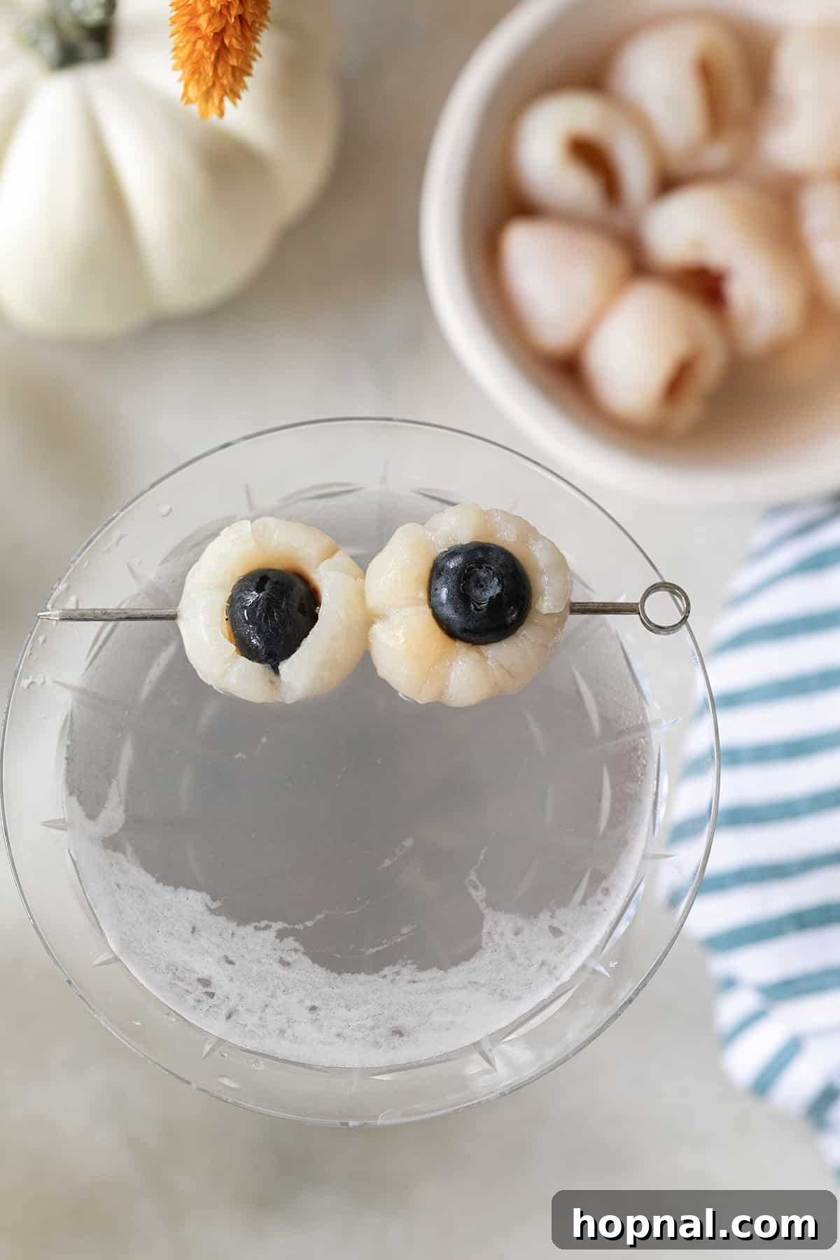 A Halloween lychee martini with spooky lychee eyeball garnishes.