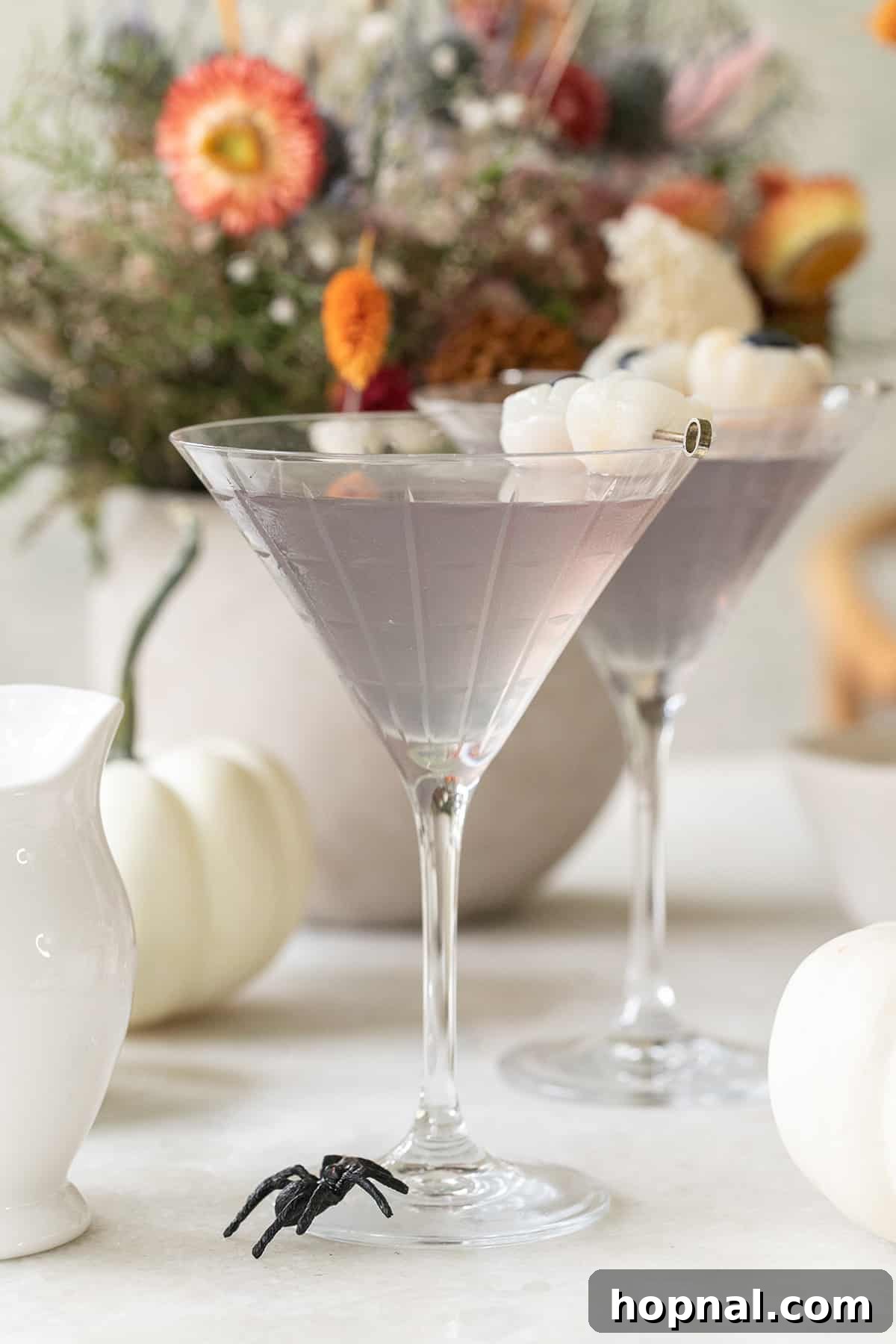 Lychee martini recipe showing the light purple color achieved with butterfly pea flowers.