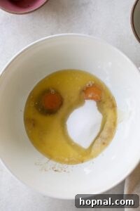 Eggs, sugar and butter in a mixing bowl.
