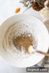 Flour and apple batter in a mixing bowl.