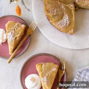 apple upside down cake on a pink plate with whipped cream.
