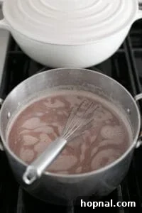 Mixing peppermint hot chocolate in a saucepan.